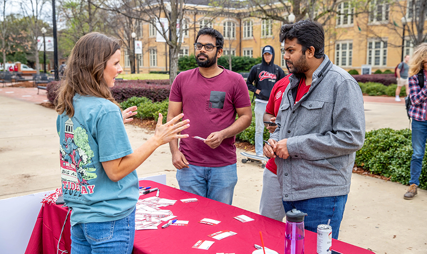 SGA student talking to other UA students at tabling event